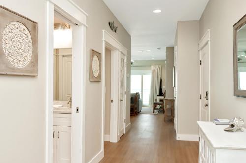 a kitchen with white walls and a hallway with white cabinets at The Great White 1 by Pristine Properties Vacation Rentals in Beacon Hill