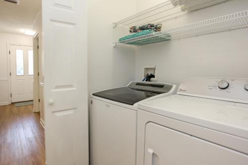 a white laundry room with a washer and dryer at 2-The-Beach by Pristine Properties Vacation Rentals in Indian Pass