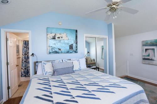 a bedroom with a large bed with blue walls at 2-The-Beach by Pristine Properties Vacation Rentals in Indian Pass