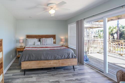 a bedroom with a bed and a balcony at A New Beginning by Pristine Properties Vacation Rentals in Indian Pass