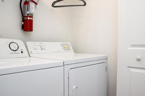 a white laundry room with a washer and dryer at Gulfside GEM by Pristine Properties Vacation Rentals in Indian Pass