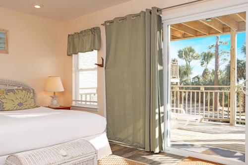 a bedroom with a bed and a sliding glass door at Gulfside GEM by Pristine Properties Vacation Rentals in Indian Pass