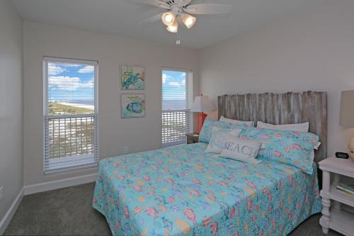 a bedroom with a bed with a view of the ocean at Surfside 16 by Pristine Properties Vacation Rentals in Mexico Beach