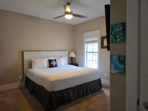 a bedroom with a bed with a ceiling fan at Barefoot Cottage B37 by Pristine Properties in Highland View