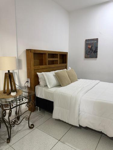 a bedroom with a large bed and a table at Habitación centro in Ciudad del Este