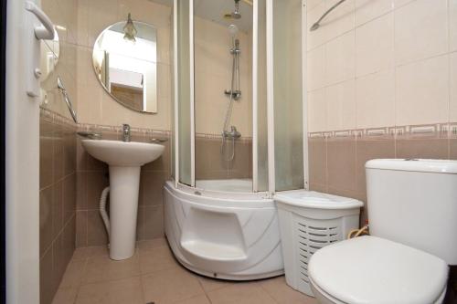 a bathroom with a toilet and a sink and a shower at The Best Apartment in Yerevan