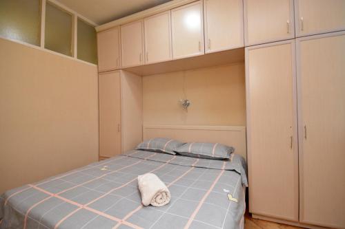 a bedroom with a bed with a towel on it at The Best Apartment in Yerevan