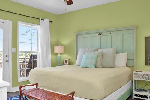 a bedroom with a large bed and a window at Rehoboth Cottage by Pristine Properties Vacation Rentals in Indian Pass