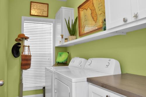 a laundry room with a washer and dryer at Rehoboth Cottage by Pristine Properties Vacation Rentals in Indian Pass