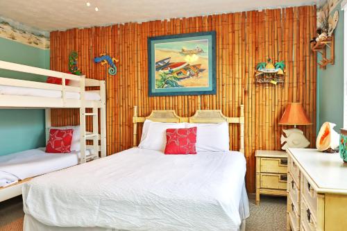 a bedroom with two bunk beds and red pillows at Sea Shell by Pristine Properties Vacation Rentals in Mexico Beach