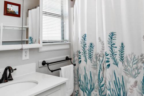 a bathroom with a sink and a shower curtain at Sea Shell by Pristine Properties Vacation Rentals in Mexico Beach