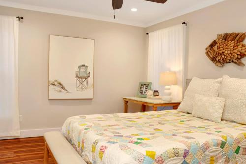 a bedroom with a bed and a table with a lamp at The Surf Ranch by Pristine Properties Vacation Rentals in Port Saint Joe