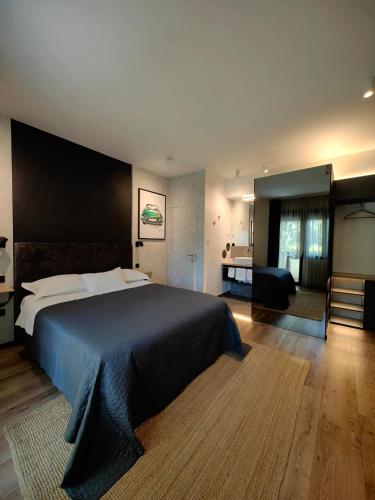 a bedroom with a large bed and a living room at Scuderia Split Rooms in Split