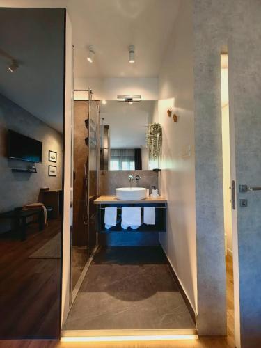 a bathroom with a sink and a mirror at Scuderia Split Rooms in Split
