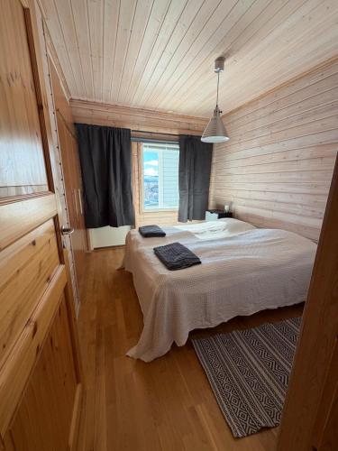 a bedroom with two beds and a window at Kilpis-Silent Apartment in Kilpisjärvi