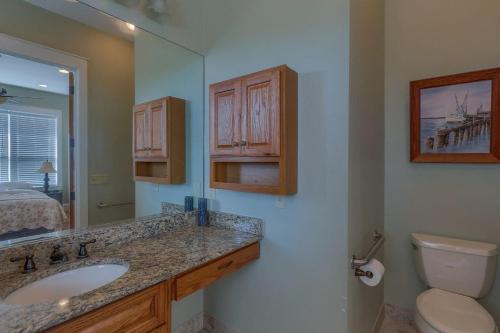 a bathroom with a sink and a toilet at Camp Palms @ Indian Pass by Pristine Properties Vacation Rentals in Indian Pass