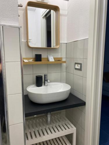 a bathroom with a sink and a mirror at MARIMA' la Casa Vacanze - Holidays Suites in Maratea