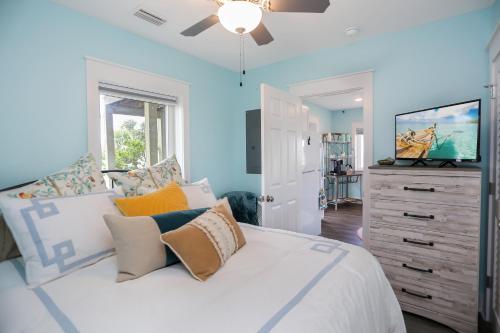 a bedroom with blue walls and a bed with pillows at Beach View Lower by Pristine Properties Vacation Rentals in Mexico Beach