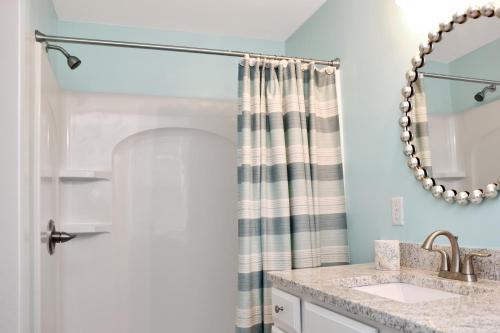 a bathroom with a sink and a shower curtain at Beach View Upper by Pristine Properties Vacation Rentals in Mexico Beach