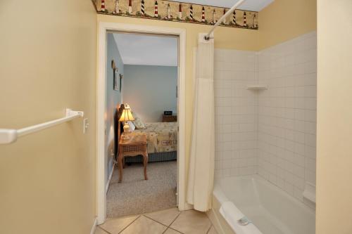 a bathroom with a tub and a bedroom with a bed at DeLight House by Pristine Properties Vacation Rentals in Indian Pass