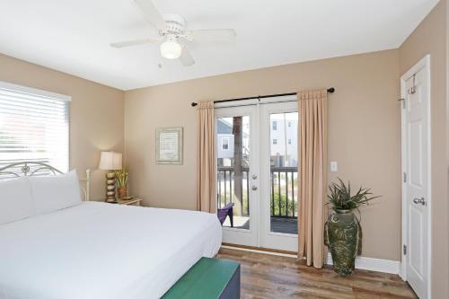 a bedroom with a bed and a sliding glass door at Narrow Escape by Pristine Properties Vacation Rentals in Cape San Blas
