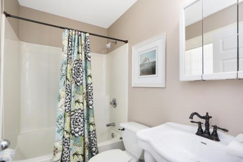 a bathroom with a toilet and a sink at Narrow Escape by Pristine Properties Vacation Rentals in Cape San Blas