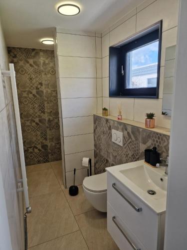a bathroom with a toilet and a sink at Ferienhaus Holstein in Butjadingen