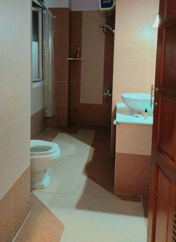 a bathroom with a toilet and a sink at Perla Home in Danang