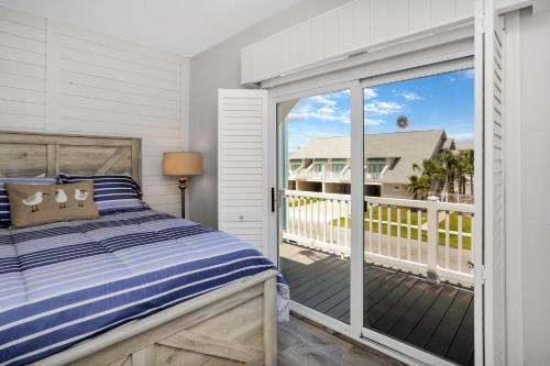a bedroom with a bed and a balcony at Set Sail at 5 by Pristine Properties Vacation Rentals in Mexico Beach