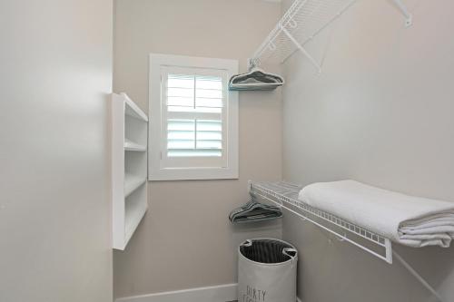 a small white room with a shelf and a window at Second Chance by Pristine Properties Vacation Rentals in Mexico Beach