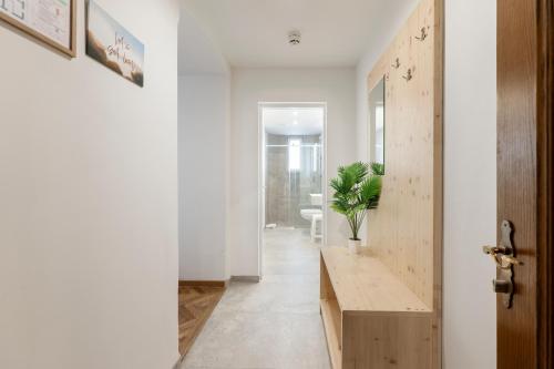 a hallway with white walls and a wooden door at Hotel Gisela in Kufstein