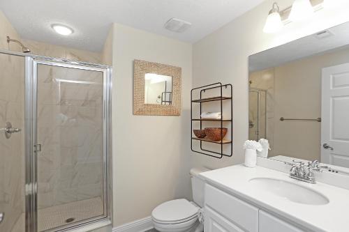 a bathroom with a shower and a toilet and a sink at Summerhouse 209 by Pristine Properties Vacation Rentals in Mexico Beach
