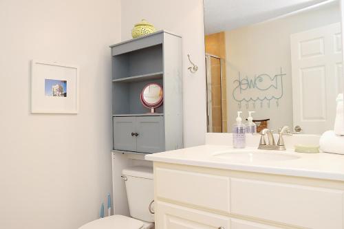 a white bathroom with a sink and a toilet at Summerhouse 309 by Pristine Properties in Mexico Beach