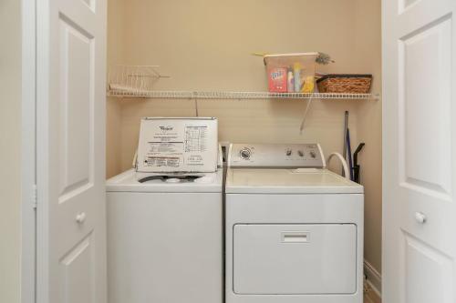 a washer and dryer in a small kitchen at Summerhouse 203 by Pristine Properties Vacation Rentals in Mexico Beach