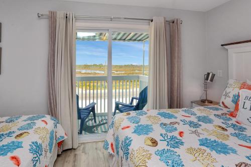 a bedroom with a bed and a balcony at Their Inheritance by Pristine Properties Vacation Rentals in Indian Pass