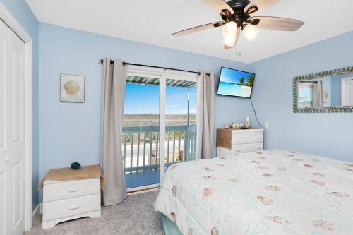 a bedroom with a bed and a window with a view at Beach Therapy by Pristine Properties Vacation Rentals in Cape San Blas