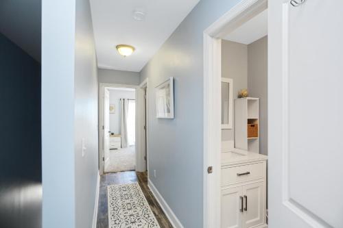 a hallway with white cabinets and a white door at Beach Therapy by Pristine Properties Vacation Rentals in Cape San Blas