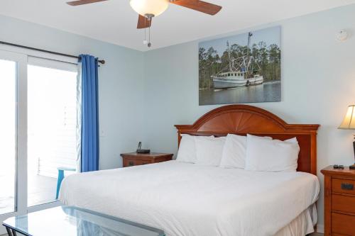 a bedroom with a bed and a glass table at Whataday by Pristine Properties Vacation Rentals in Cape San Blas