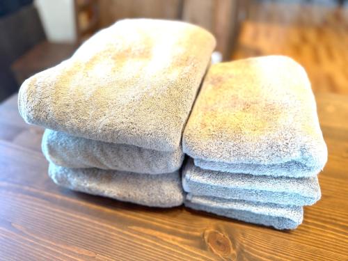 a pile of towels sitting on top of a table at Ango KIKAIJIMA in Onozu