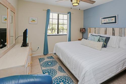 a bedroom with a large bed and a tv at Pelican Bend by Pristine Properties Vacation Rentals in Indian Pass