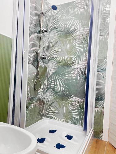 a bathroom with a shower with a glass door at Chalet del girasole in Castellabate