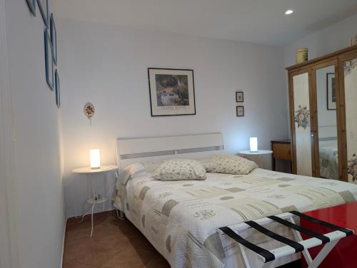 a bedroom with a bed with two tables and two lamps at Casa RoSiLù in Monopoli