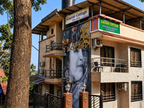 a building with a face painted on the side of it at Hotel Matheran Gaurav Cottage in Matheran