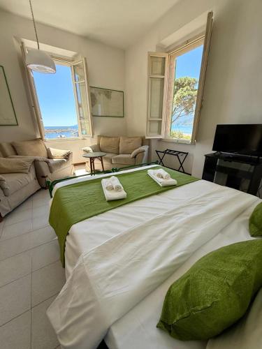 a large bed in a room with a living room at Liberty Seaview Apartment Cala Gonone in Cala Gonone