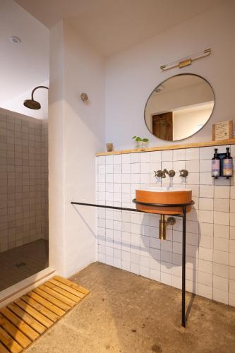 a bathroom with a sink and a mirror at VILLA FLAKA Boutique Hôtel Wellness in Cargèse