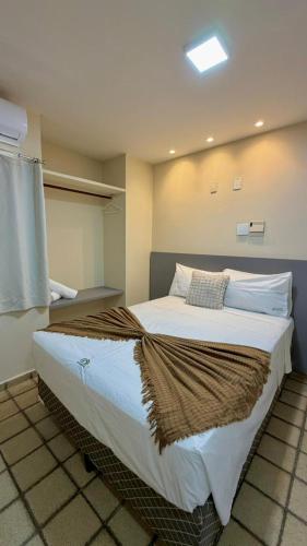 a bedroom with a large bed in a room at Hotel Pousada Arco Íris Manaira in João Pessoa