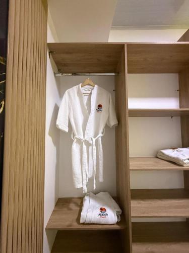 a white robe is hanging in a closet at Hotel Alikaa Guajira in Ríohacha