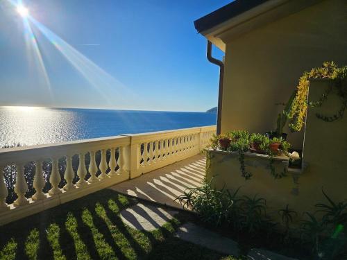 a balcony of a house with a view of the ocean at Mare e Relax - La Villetta ai Tre Ponti - Trilocale in Sanremo