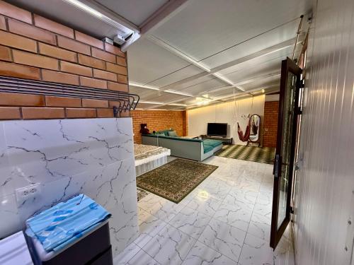 a room with a brick wall and a lobby at Duplex80A in Tashkent
