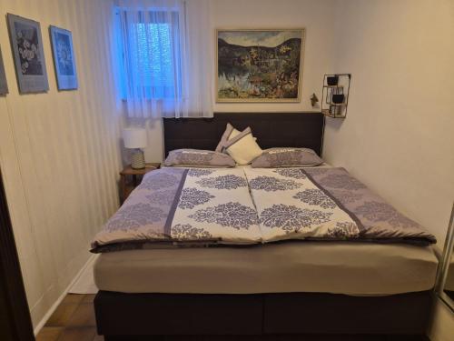 a bedroom with a bed with a comforter on it at Fewo Amber in Heimbach